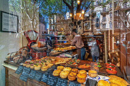 PALMA, SPAIN - APRIL 11, 2019: Street reflection in a glass showcase and freshly baked traditional mallorcan pastries of Fornet de la Soca - famous family-run bakery founded in 2008, specializing in traditional cuisine of Mallorca, Spain.のeditorial素材