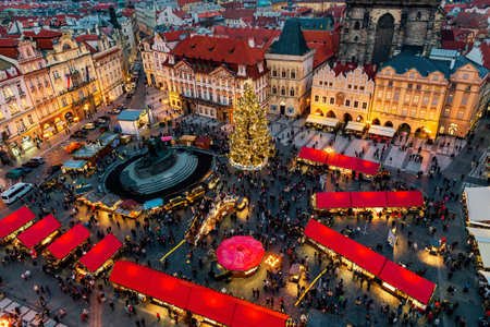 PRAGUE, CZECH REPUBLIC - DECEMBER 10, 2015: View from above of illuminated Christmas tree, market kiosks with red roofs and people on Old Town Square in Prague, Czechia.のeditorial素材