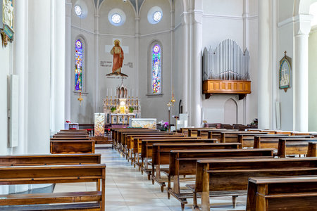 ALBA, ITALY - JUNE 23, 2020: View of pews, altar and organ inside of Divin Maestro - a roman catholic parish church recently renovated, located in small town of Alba in Piedmont, Northern Italy.のeditorial素材