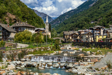View of alpine river, small town of Fontainemrore and mountains in Aosta Valley, Italy.の写真素材