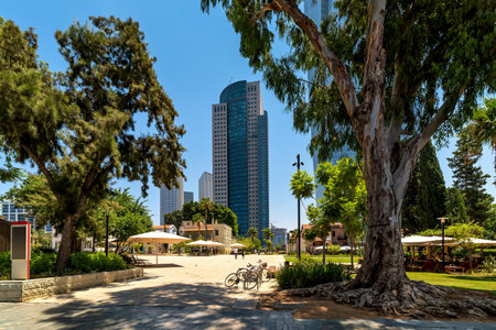 Urban park and modern skyscrapers under blue sky on background at Sarona market in Tel Aviv, Israel.の写真素材