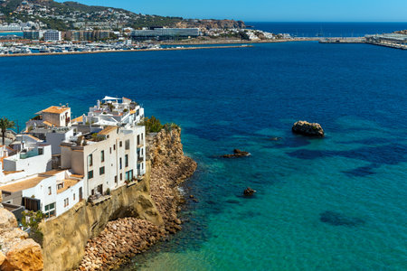 White residential houses on the cliff overlooking Mediterranean sea in Eivissa, Ibiza, Spain.の写真素材