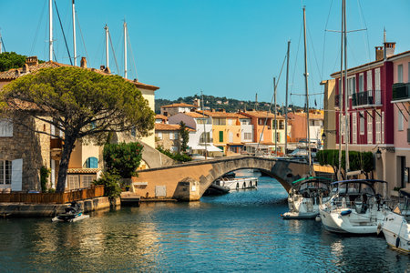 Yachts on the canal among houses and bridge in the town of Port Grimaud on French Riviera.の写真素材