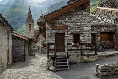 A picturesque view of a traditional alpine stone village with old church among old stone houses in Bonneval sur Arc, France.の写真素材