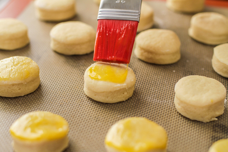 Glazing scones with brush ready to go in the owenの写真素材
