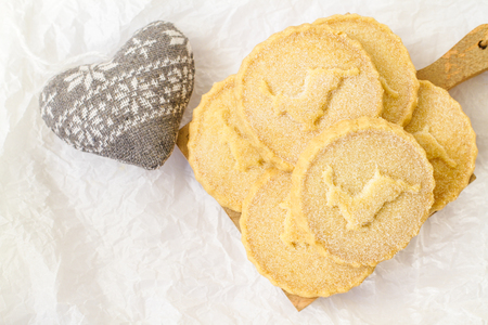 Shortbread biscuits on the white surface with the heat shape toyの写真素材