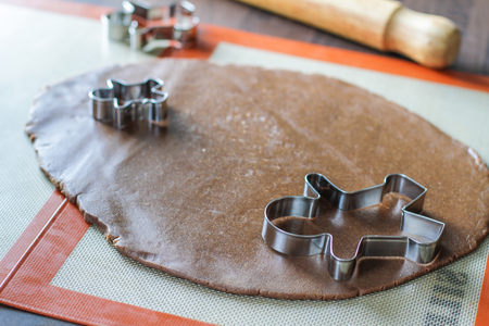 Cutting man shape figurines with a metal cutterの写真素材