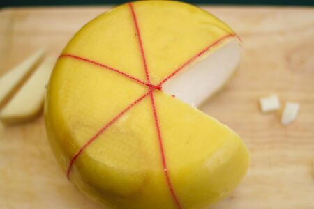 Fresh cheese in pac-man shape on the boardの写真素材