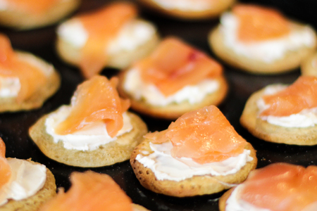 Red Fish Canapes with the cream on dark boardの写真素材