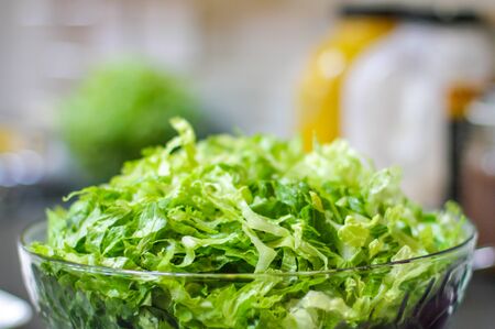 Bowl of freshly washed salad with blurred backgroundの写真素材