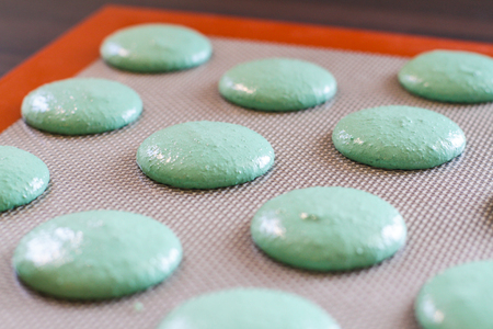 mixture for baking green macarons on the baking trayの写真素材