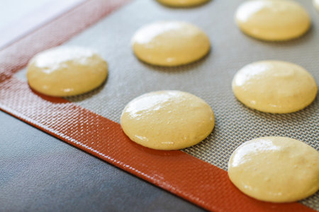 mixture for baking yello macarons on the baking tray