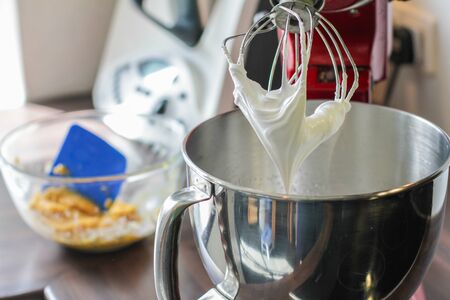 Big mixing Whisk full of white creamの写真素材