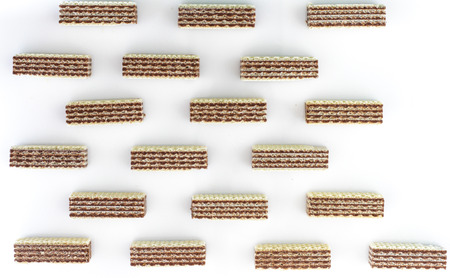 a wafer is a crisp, often sweet, very thin, flat, and dry biscuit, often used to decorate ice cream, and also used as a garnish on some sweet dishes.の写真素材