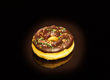 Tasty and deliciously looking donuts on black backgroundの写真素材