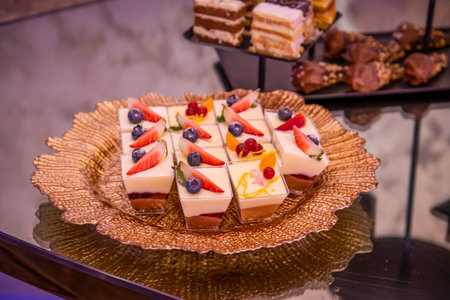 chocolate cake with frosting and sprinkles on a brown plateの写真素材