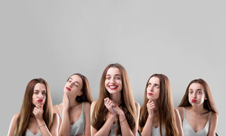 Collage of beautiful woman with different facial expressions on grey backgroundの写真素材