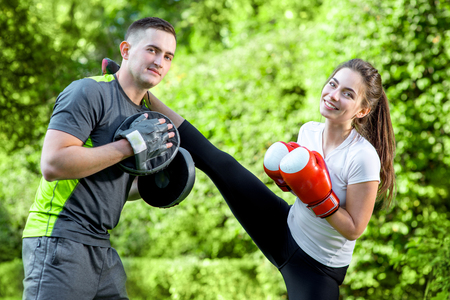Young sports couple training to box in the parkの写真素材