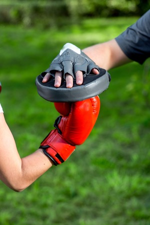 Hands in boxing gloves on the green backgroundの写真素材