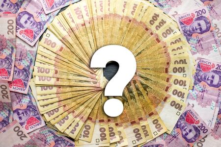 Pile of ukrainian money, hundred and two hundred banknots with question markの写真素材