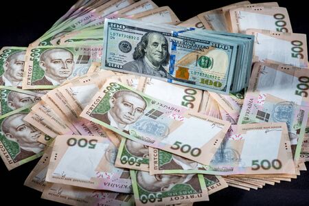 Pile of Ukrainian and American money banknotsの写真素材