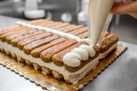 Making tiramisu cookies with savoiardi and mascarpone in the restaurant kitchenの写真素材