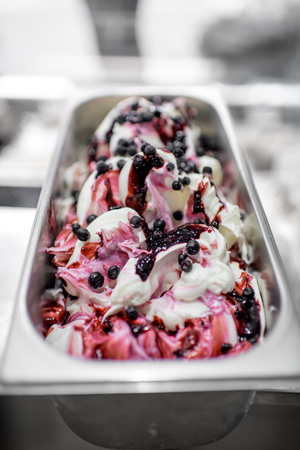 Vannila ice cream decorated with blueberries in the metal tray in the shopの写真素材