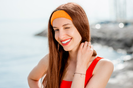 Young sport woman portrait on the beach in the morningの写真素材
