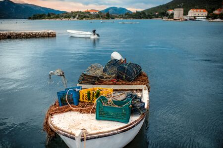 Fishermans boat with fishing tools on the coastの写真素材