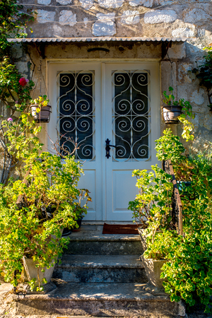 Vintage old house door with flowers and stairsのeditorial素材