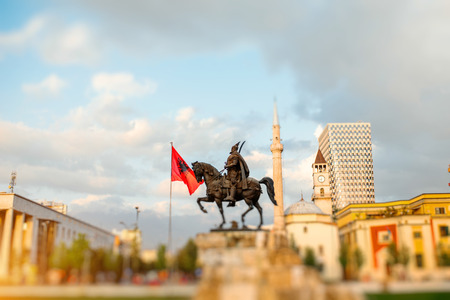 Skanderbeg square with flag, monument, mosque and clock tower in the center of Tirana city, Albania.の写真素材