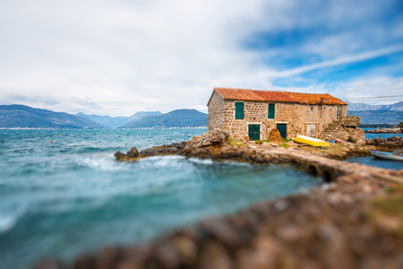 Old marina with lonely House and boat in Montenegroの写真素材