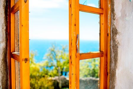 Old wooden window with view on seascapeの写真素材