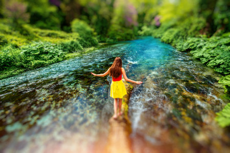 Young girl walking on the tree in the forest river