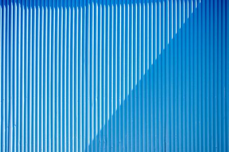Blue painted abstract striped roofing slat backgroundの写真素材