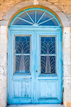 Old blue painted vintage door in Greeceの写真素材