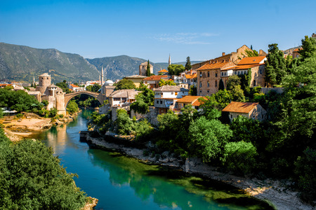 Beautiful view on Mostar city with old bridge and ancient buildings on Neretva river in Bosnia and Herzegovinaの写真素材