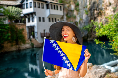 Woman with Bosnian flag in Blagaj village. Promoting tourism in Bosnia and Herzegovinaの写真素材