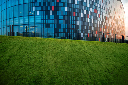 Modern Congress Hall building fragment with green lawn in Krakowの写真素材