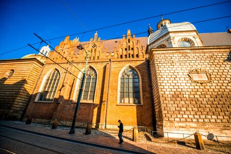 Krakow, POLAND - OCT 09, 2015: Man walking the street near St. Andrews church in old city center on the sunny morningのeditorial素材