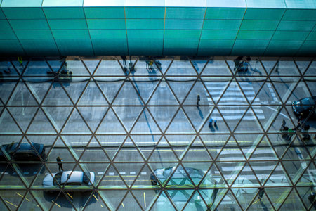 Modern airport terminal facade with cars and people's reflectionsの写真素材