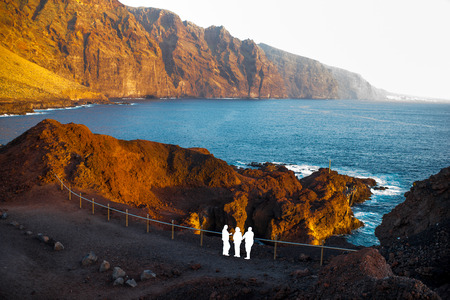 Graphic silhouettes of people painted white on the rocky coast on the cape Teno on the Tenerife island.の写真素材