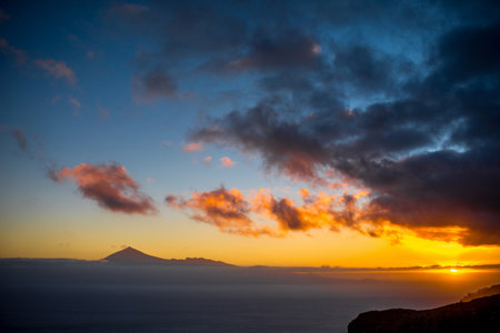Beautiful seascape view with Tenerife island contour and clouds on the sunrise in Spainの写真素材