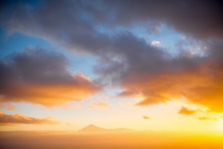 Beautiful seascape view with Tenerife island contour and clouds on the sunrise in Spainの写真素材