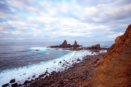Rocky coastline with sharp cliffs in the ocean on the western part of La Gomera island near Arguamul village in Spainの写真素材
