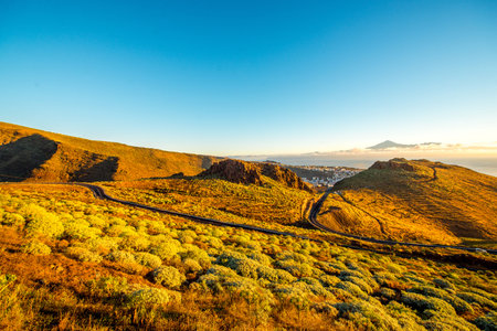 Landscape view with mountain road near San Sebastian city with Tenerife island on the background in the morningの写真素材
