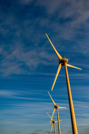 Electric windmills on the sky background on the sunset
