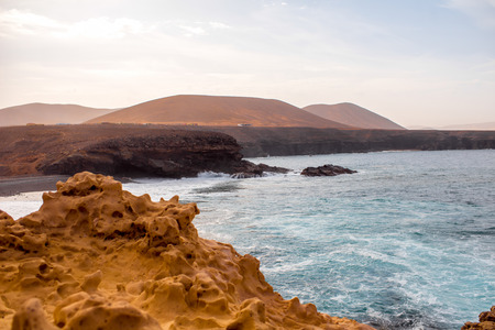 White stone coast near Ajuy village at Payara munipalicity with mountains on background on Fuerteventura island in Spainの写真素材