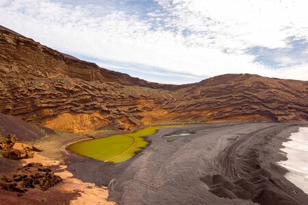 El Golfo bay with volcanic green water pool on Lanzarote island in Spainの写真素材