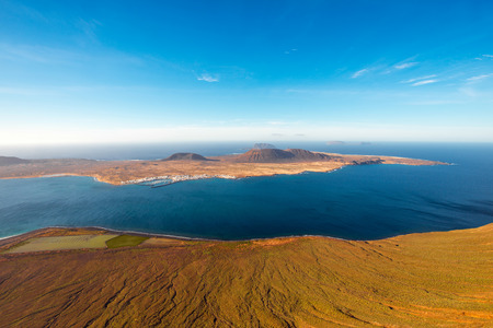Wide angle view on Graciosa island from El Rio viewpoint on Lanzarote island in Spainの写真素材